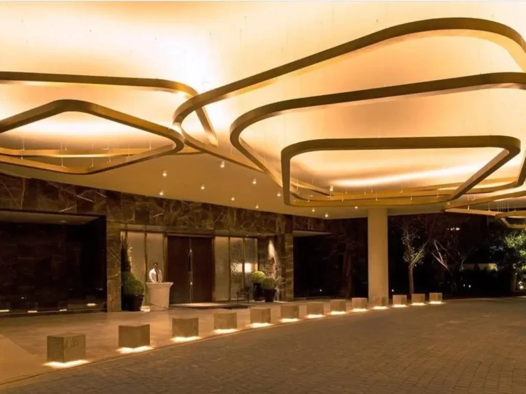 A stunning double-height lobby with marble finishes and curated artworks at DLF camellias.